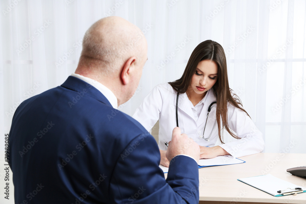 Young female doctor receiving patient in her office Young female doctor receiving patient in her office