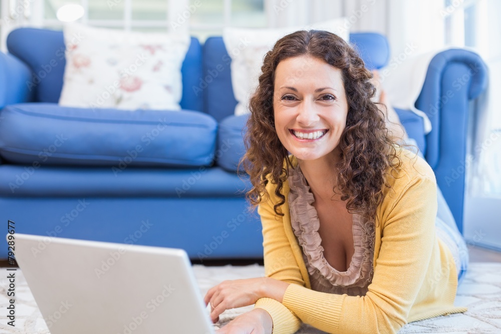 Pretty brunette lying on the floor and using laptop Pretty brunette lying on the floor and using laptop