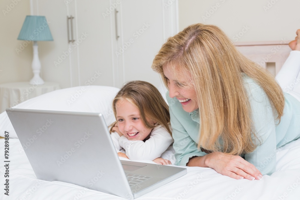 Happy mother and daughter using laptop Happy mother and daughter using laptop