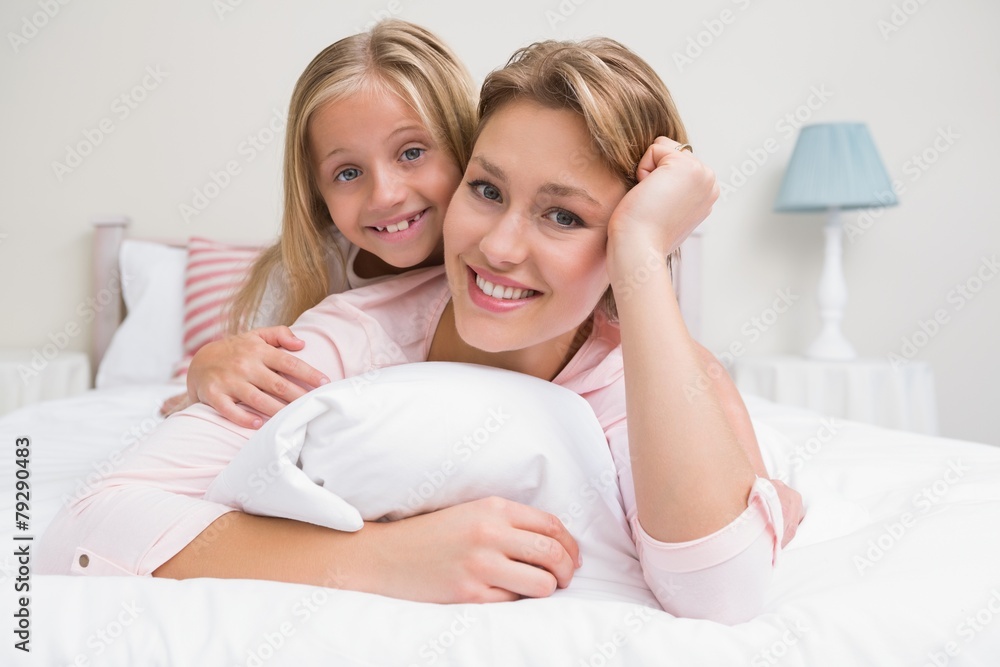 Mother and daughter smiling at camera Mother and daughter smiling at camera