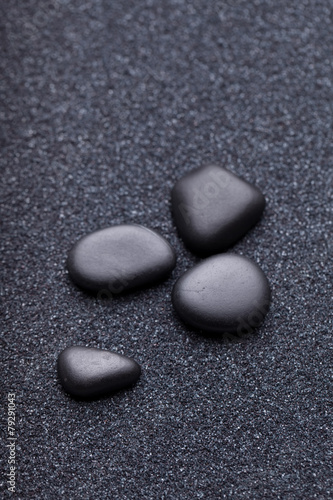 Black stones in the relaxing zen garden sand