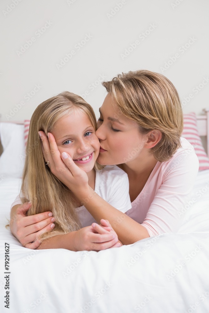 Mother and daughter smiling at camera