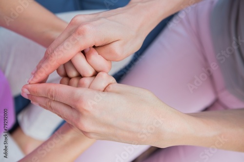 Mother and daughter touching hands