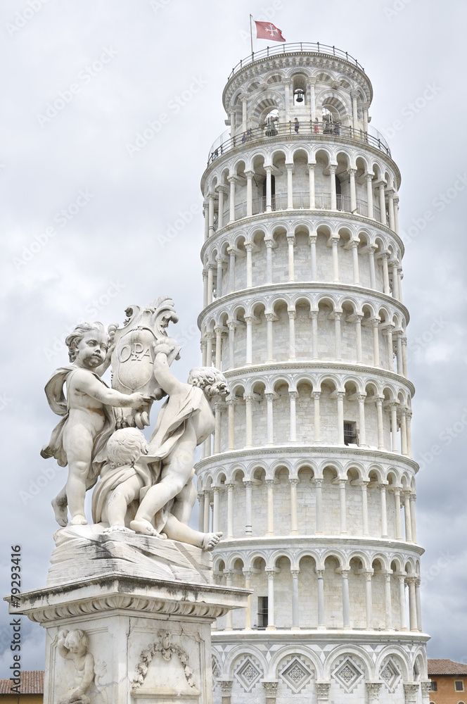 Statue of cherubs and the leaning tower of Pisa, Italy