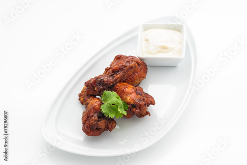Deep fried chicken with tartar sauce on white plate
