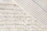 White knitted blanket folded in layers