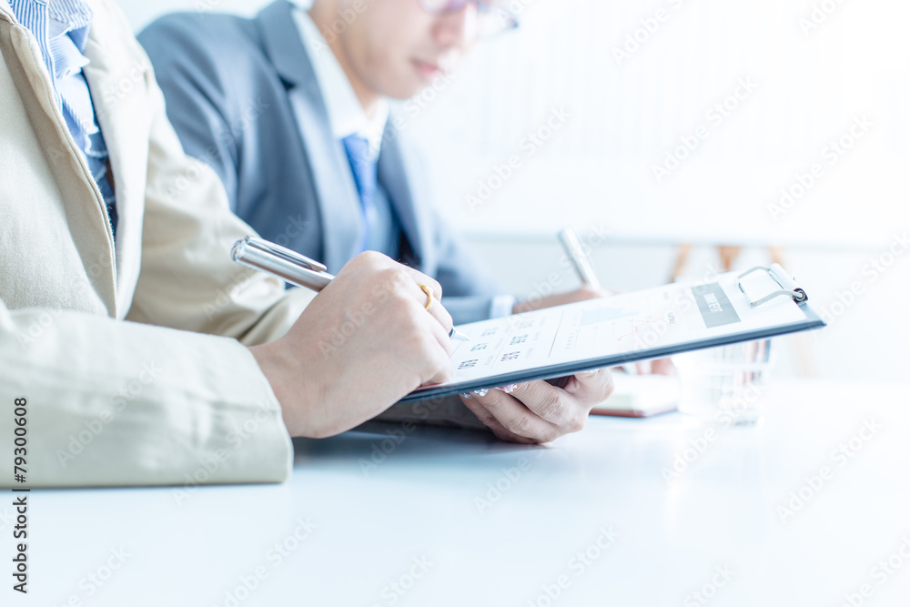 Business people discussing the charts and graphs showing the res Business people discussing the charts and graphs showing the res