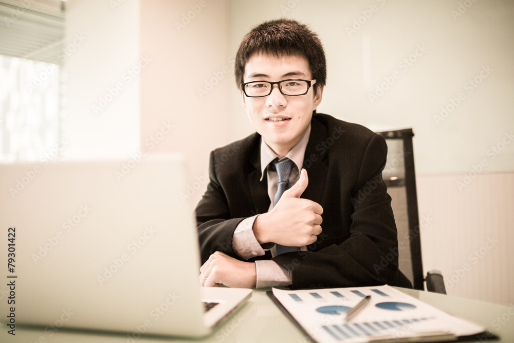 Young handsome man using laptop in his office Young handsome man using laptop in his office