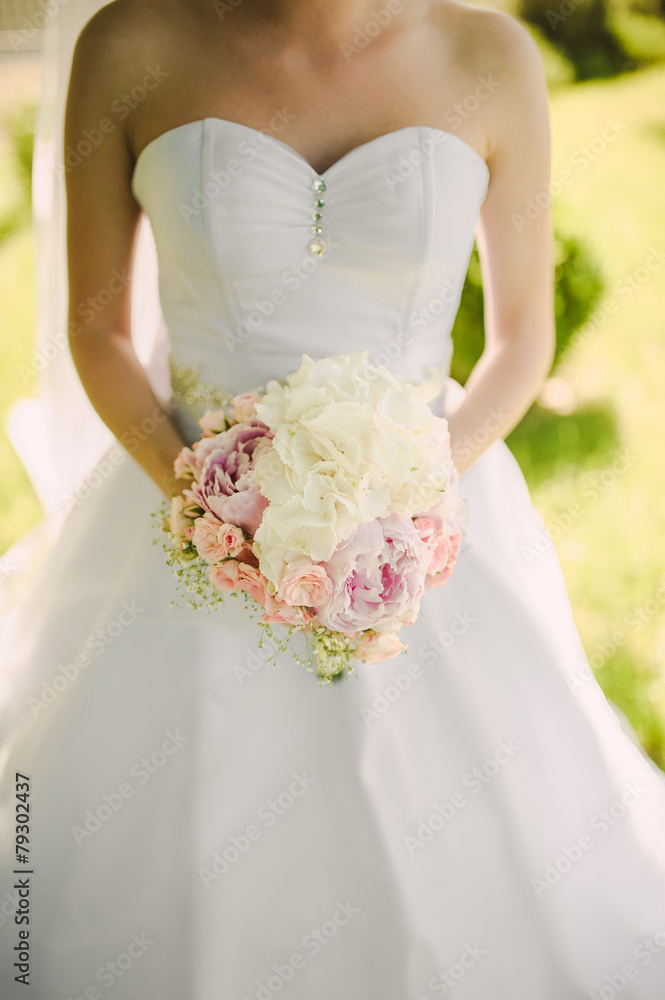 Bride holding a bouquet of beautiful flowers Bride holding a bouquet of beautiful flowers