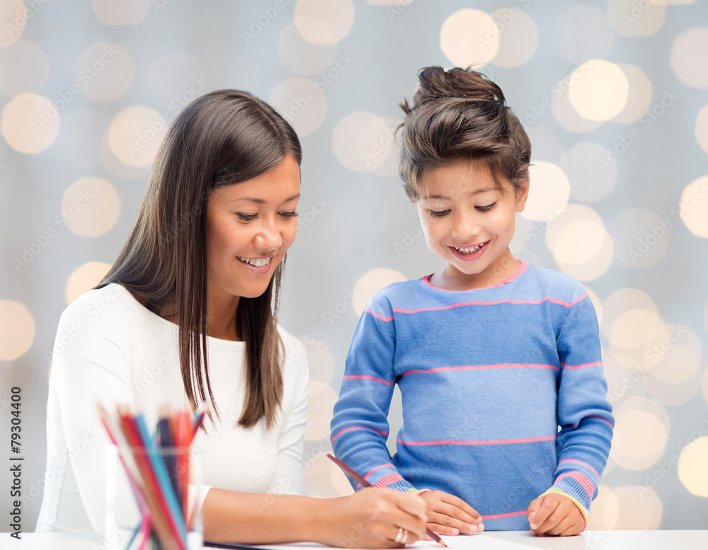 happy mother and daughter drawing with pencils happy mother and daughter drawing with pencils