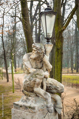 Photo Lantern with sculpture of satyr in Royal Baths Park, Warsaw