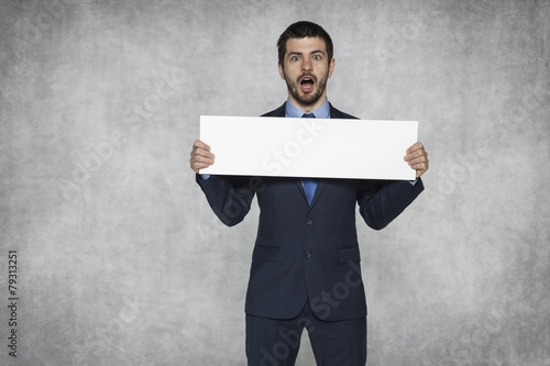 shocked businessman with a piece of paper photo