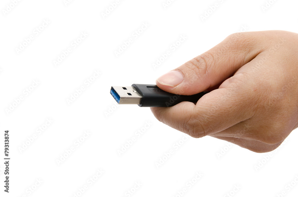 Hand holding black USB data storage Hand holding black USB data storage