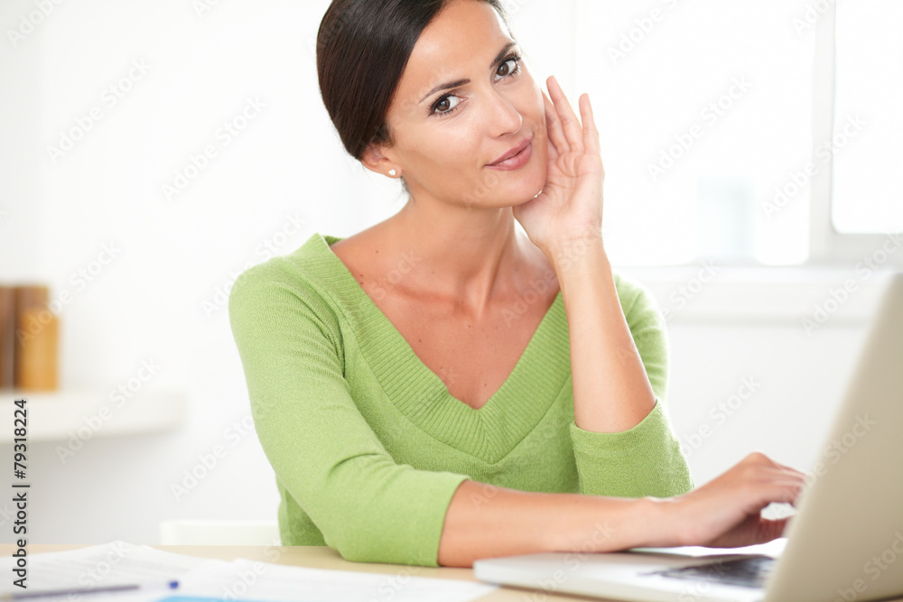Adult latin woman browsing the web on laptop Adult latin woman browsing the web on laptop