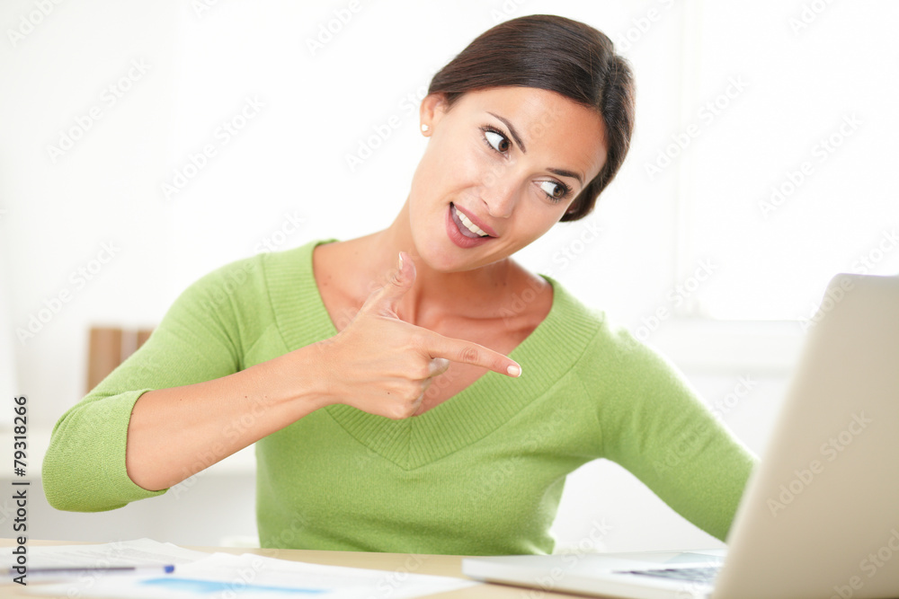 Cheerful young lady looking excited over a success