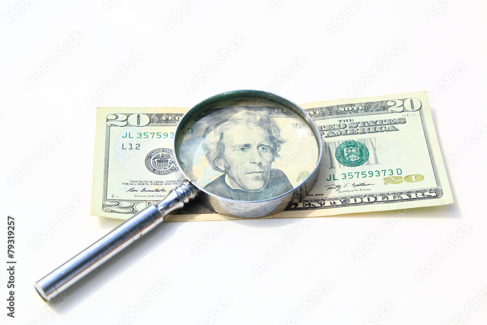 money under magnify glass isolated over white money under magnify glass isolated over white