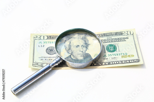 money under magnify glass isolated over white