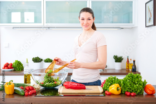 Young woman in the kitchen prepare salad VII