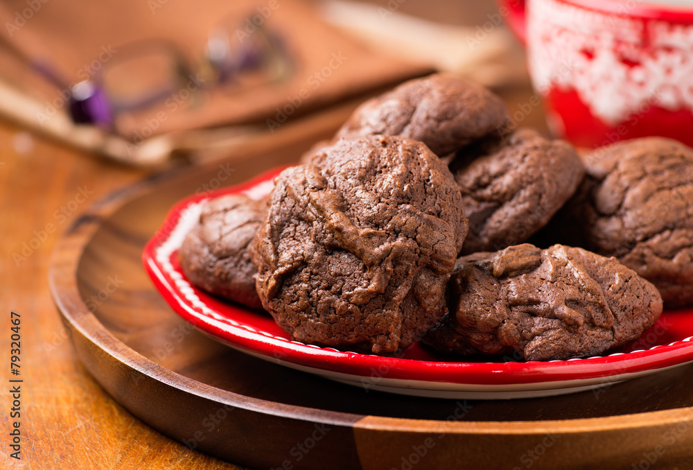 Homemade chocolate cookies on red plate Homemade chocolate cookies on red plate