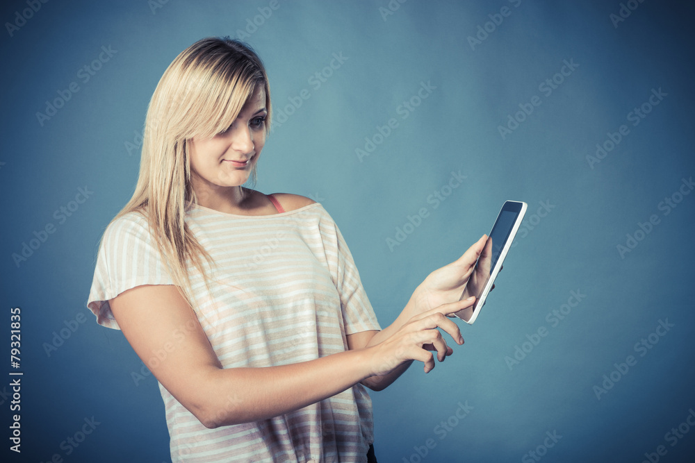 Young woman with tablet on blue Young woman with tablet on blue