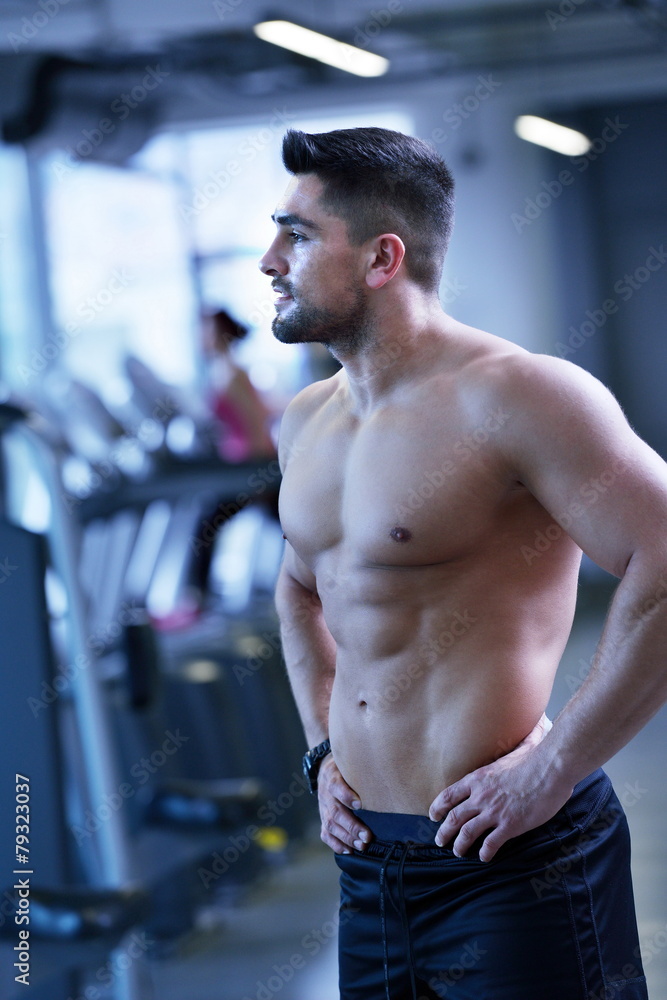 handsome man exercising at the gym handsome man exercising at the gym