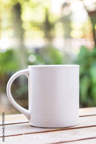 White coffee cup in garden