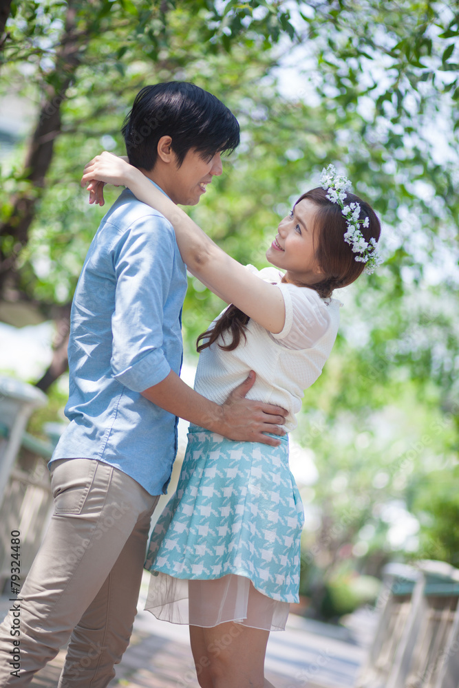 Loving asian couple under tree Loving asian couple under tree