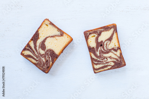 Chocolated and yellow butter marble cake on white background photo