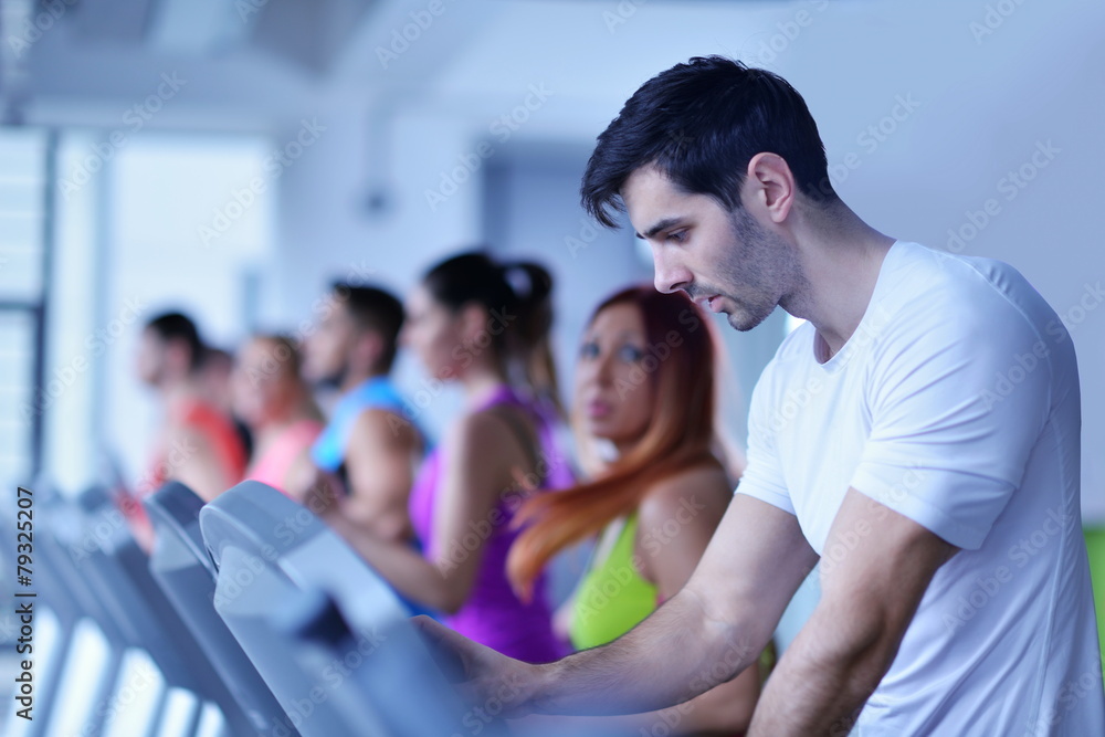 Group of people running on treadmills Group of people running on treadmills