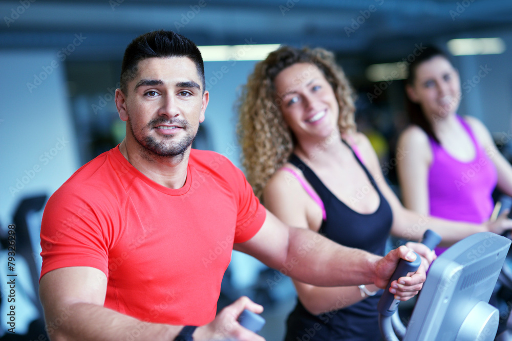 Group of people running on treadmills