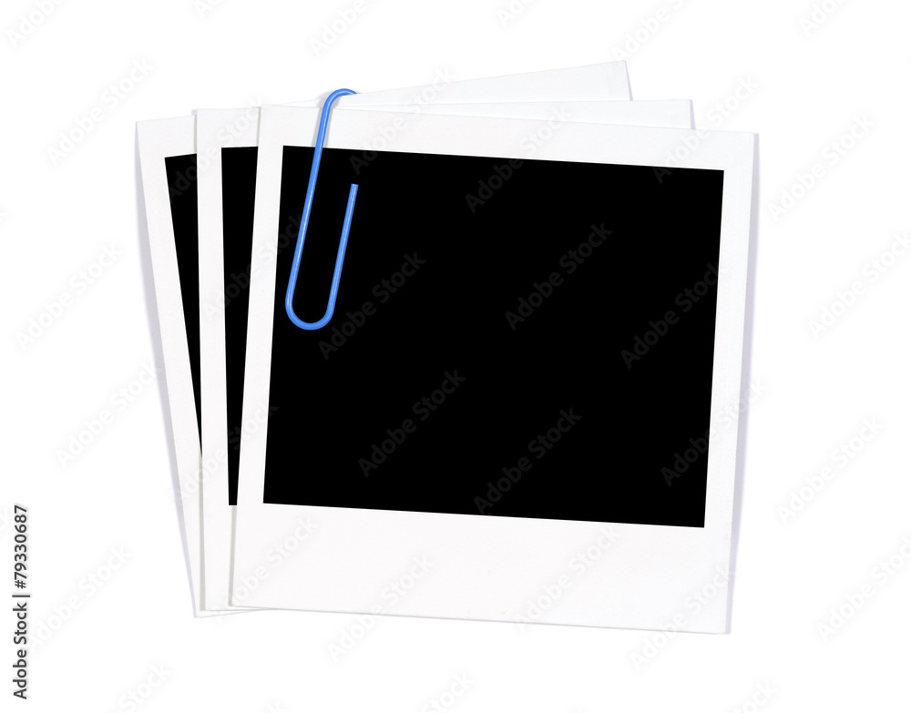 Small stack of three polaroid style photo frame print attached with paperclip isolated on white background
