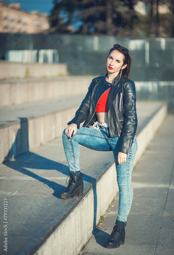 Fototapeta premium Young fashion hipster beautiful girl in leather jacket outdoor