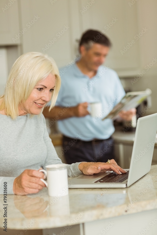 Happy mature blonde using laptop Happy mature blonde using laptop
