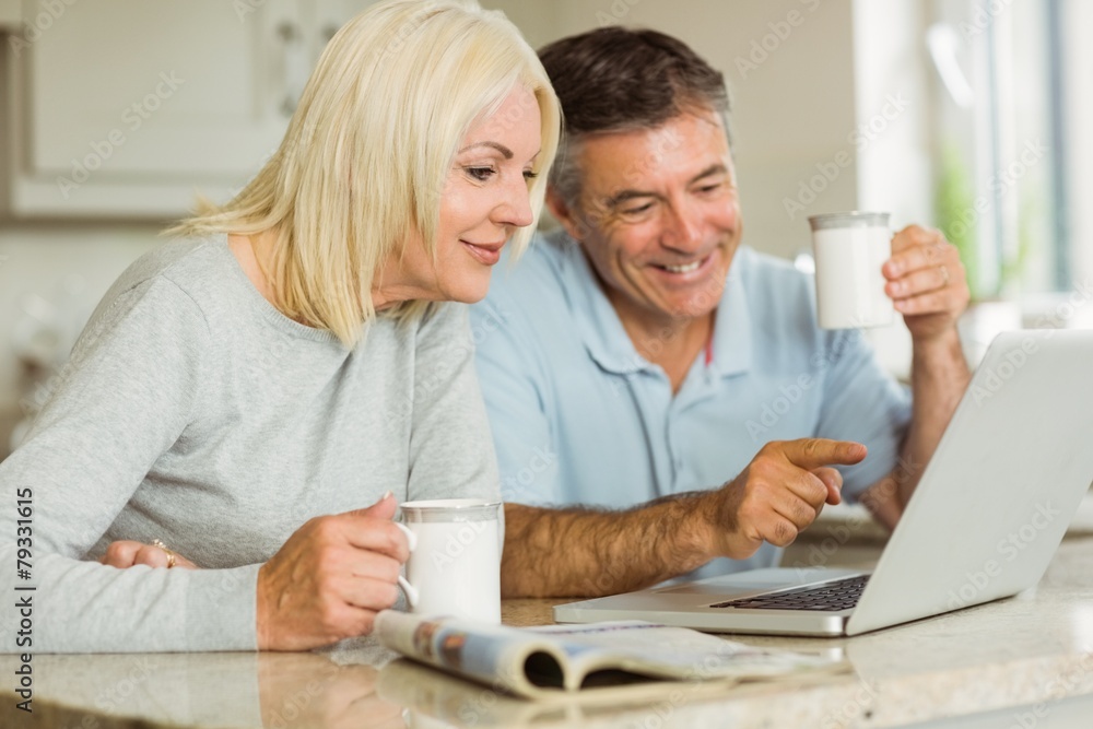 Happy mature couple using laptop Happy mature couple using laptop