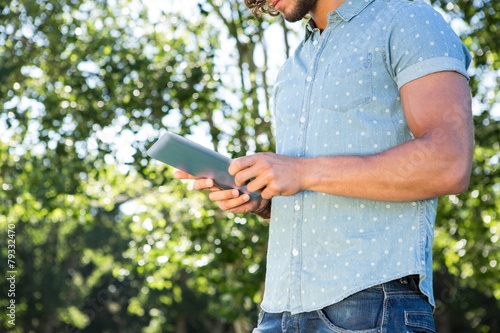 Young man using tablet in the park