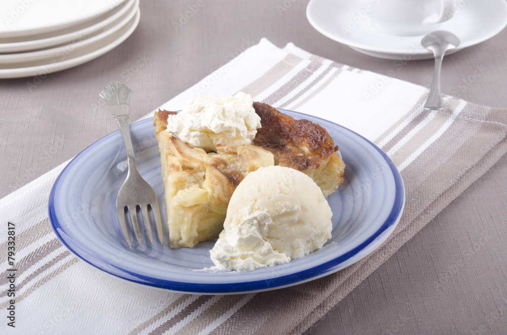 apple cake with whipped cream on a plate