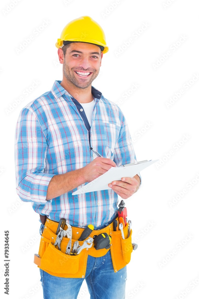 Portrait of smiling handyman writing on clipboard Portrait of smiling handyman writing on clipboard