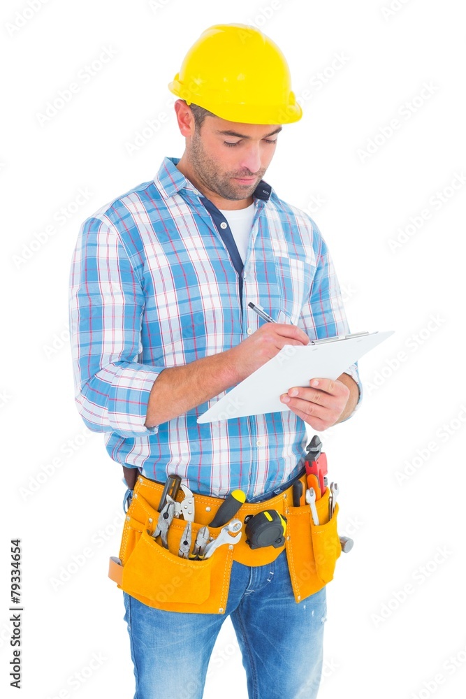 Manual worker writing on clipboard Manual worker writing on clipboard