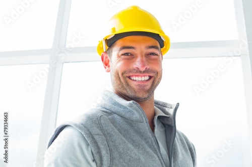 Manual worker wearing hardhat in building