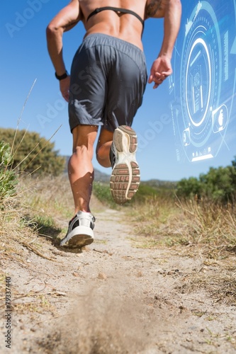 Shirtless man jogging with heart rate monitor around chest