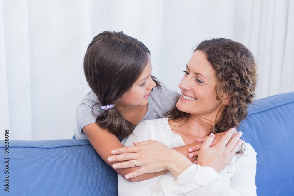 Happy mother and daughter smiling at each other Happy mother and daughter smiling at each other