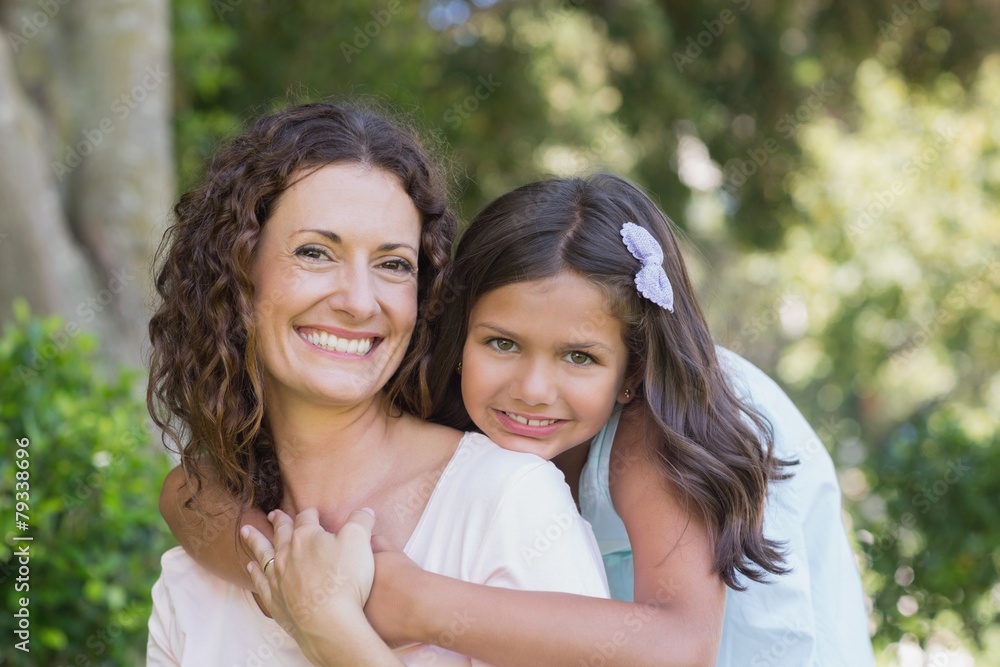 Happy mother and daughter smiling at camera Happy mother and daughter smiling at camera