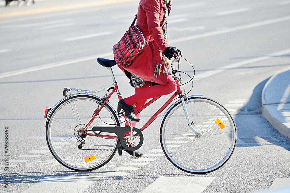 Naklejka premium Woman in red. On bike.