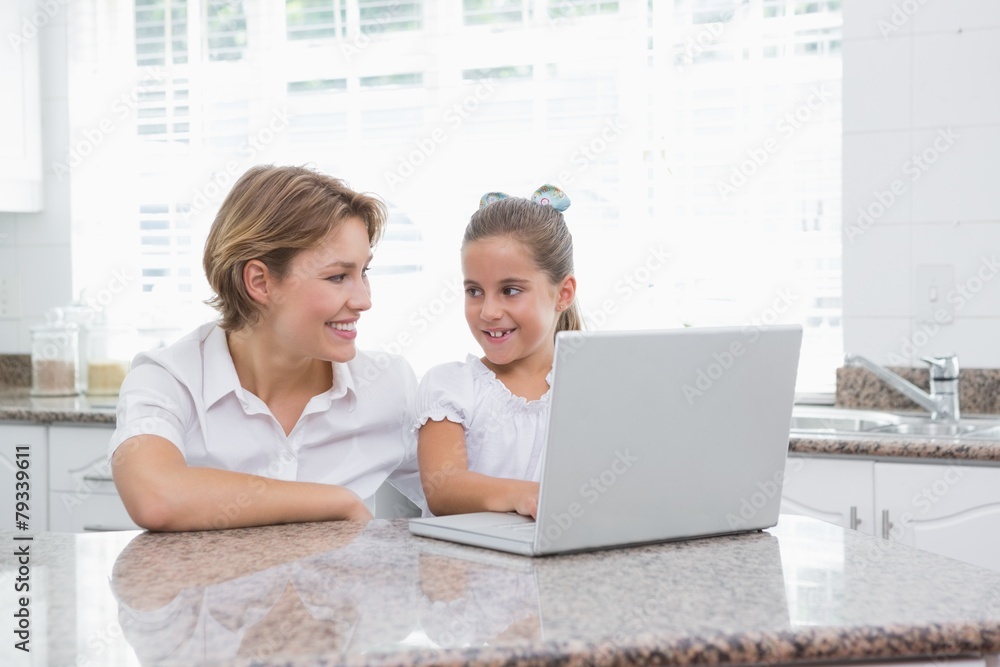 Mother and daughter using laptop Mother and daughter using laptop