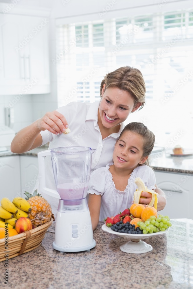 Mother and daughter making a smoothie Mother and daughter making a smoothie