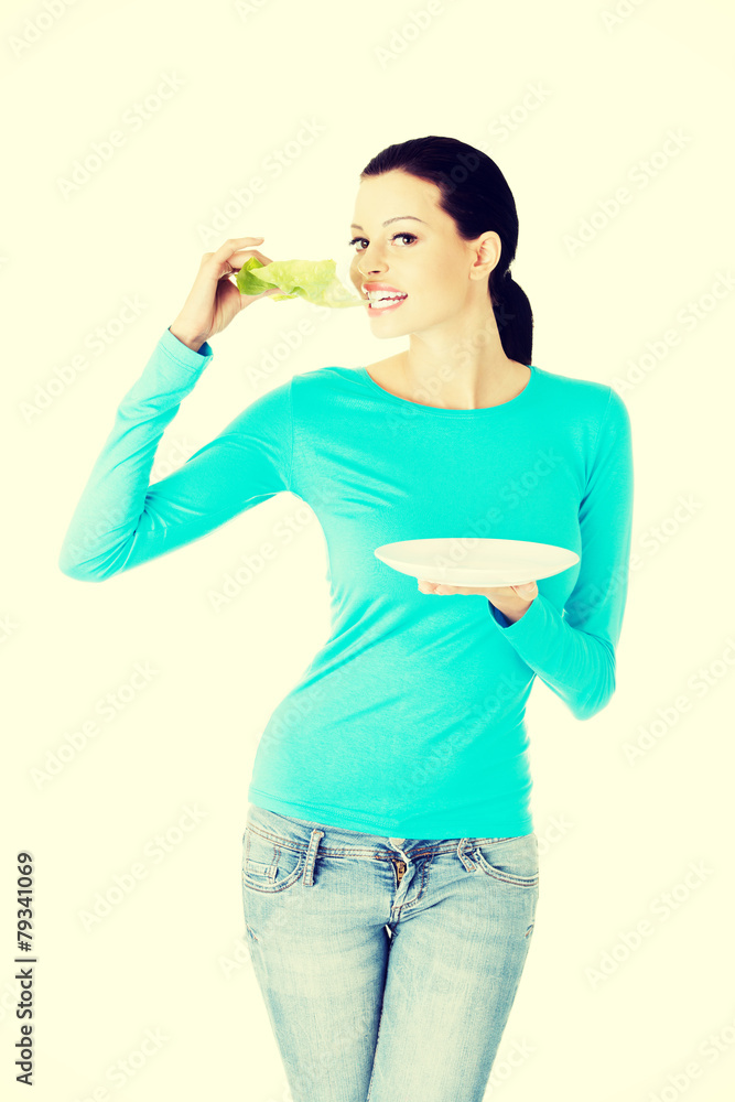 Woman eating a salad. Woman eating a salad.
