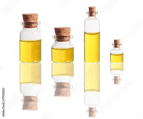 yellow liquid in bottles with cork isolated on white background