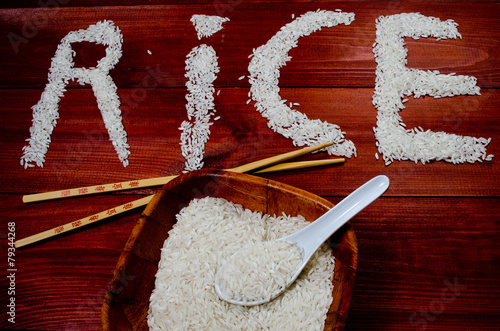 Rice on wooden table with chopsticks