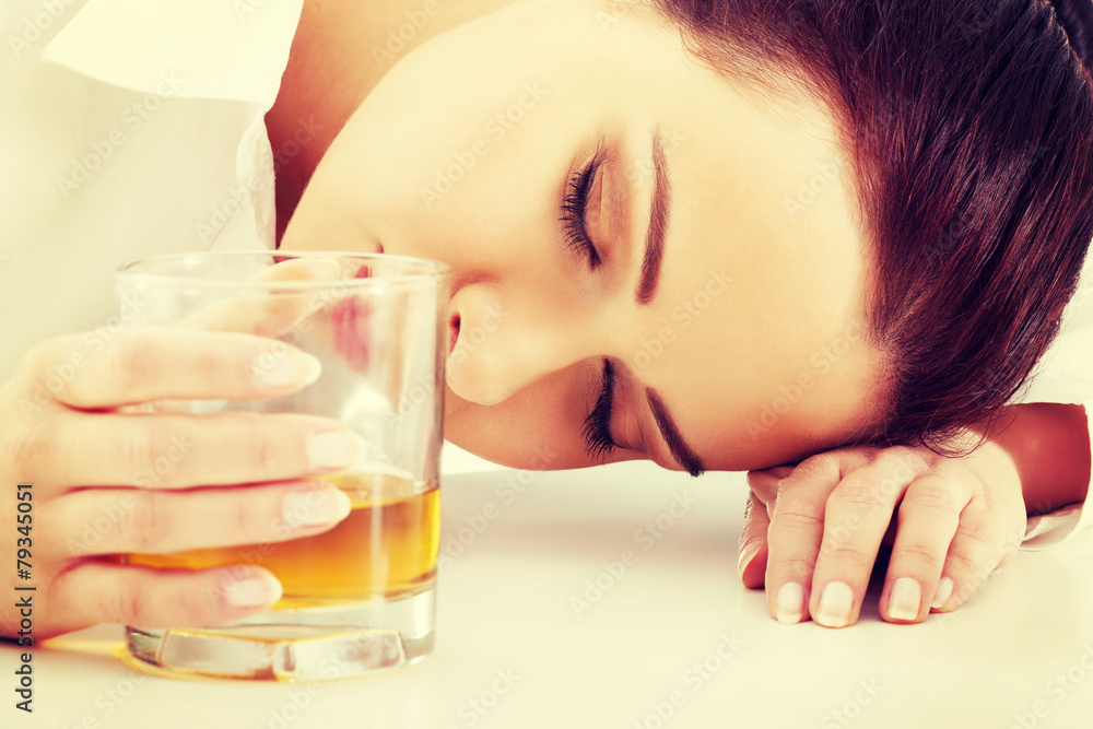 Businesswoman in depression drinking alcohol. Businesswoman in depression drinking alcohol.