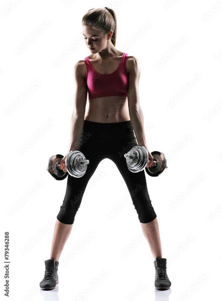 Young girl doing swing exercise with a dumbbells Young girl doing swing exercise with a dumbbells